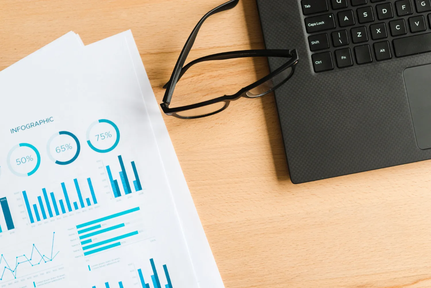 office desktop with laptop and a glasses